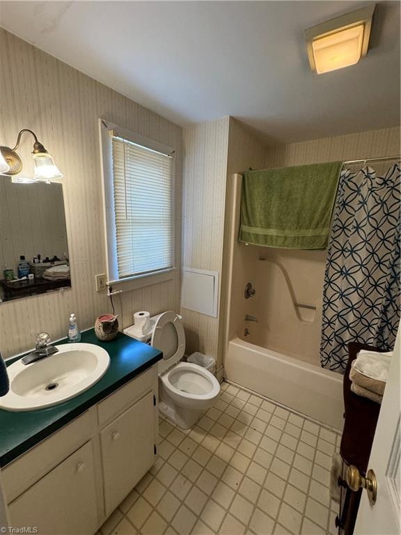 full bathroom with tile patterned flooring, vanity, toilet, and washtub / shower combination