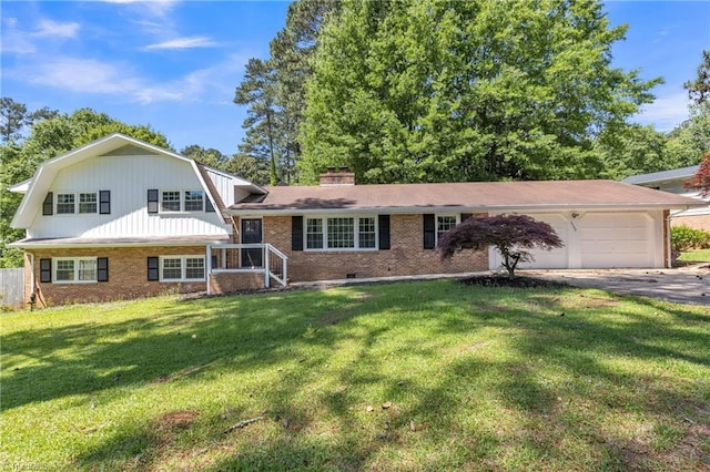 split level home with brick siding, a garage, a front yard, driveway, and a gambrel roof
