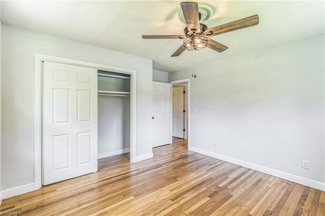 unfurnished bedroom featuring baseboards, light wood-type flooring, a closet, and ceiling fan