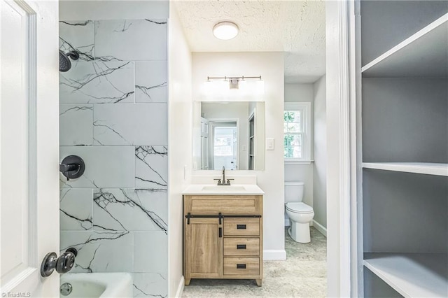 full bath with toilet, vanity, and a textured ceiling
