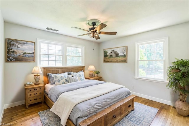 bedroom featuring baseboards, light wood-type flooring, and ceiling fan