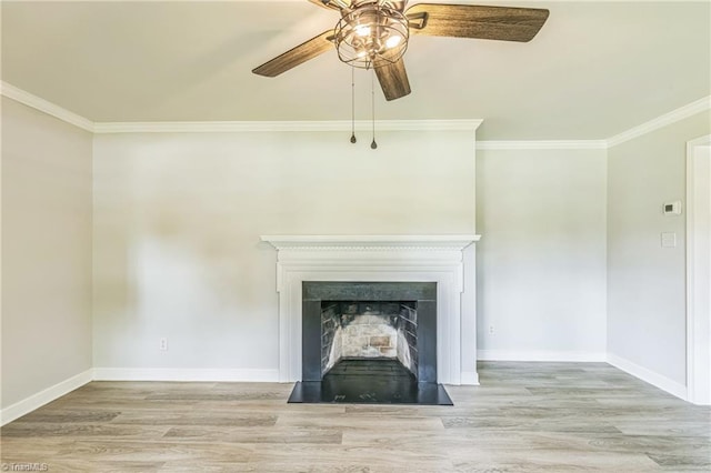 unfurnished living room with a ceiling fan, ornamental molding, wood finished floors, and baseboards