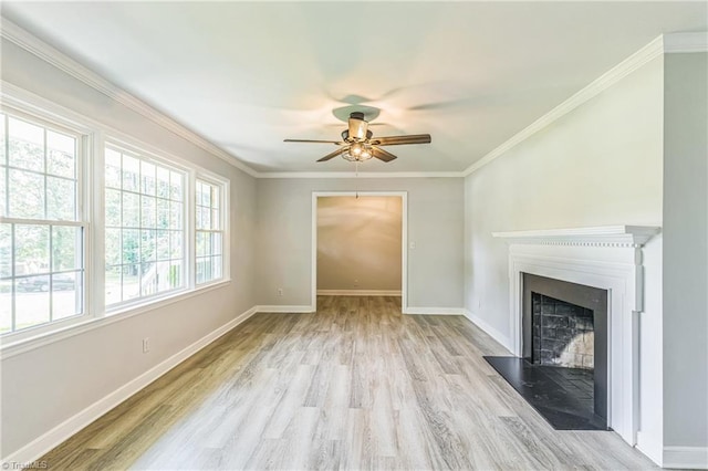unfurnished living room featuring ceiling fan, wood finished floors, baseboards, a fireplace with flush hearth, and ornamental molding