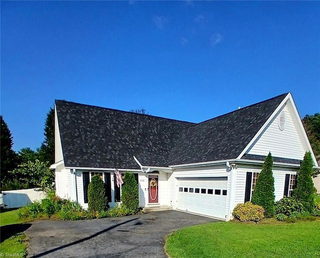 view of front of home with a garage and a front lawn