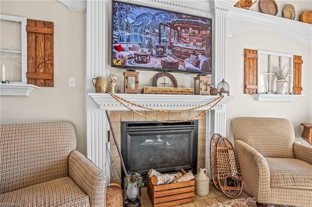 sitting room with tile patterned flooring and a fireplace