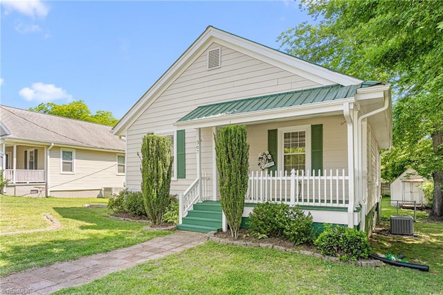 307 W Austin St, Mebane, NC 27302 - view of front facade featuring a porch, a front lawn, central AC, and metal roof