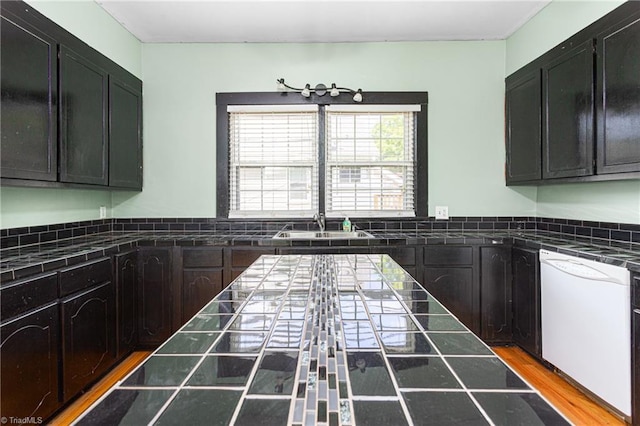 307 W Austin St, Mebane, NC 27302 - kitchen featuring white dishwasher, tile countertops, a sink, and dark cabinets