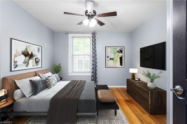 307 W Austin St, Mebane, NC 27302 - bedroom with light wood-style flooring, baseboards, and ceiling fan