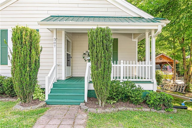 307 W Austin St, Mebane, NC 27302 - property entrance featuring covered porch, metal roof, and a standing seam roof