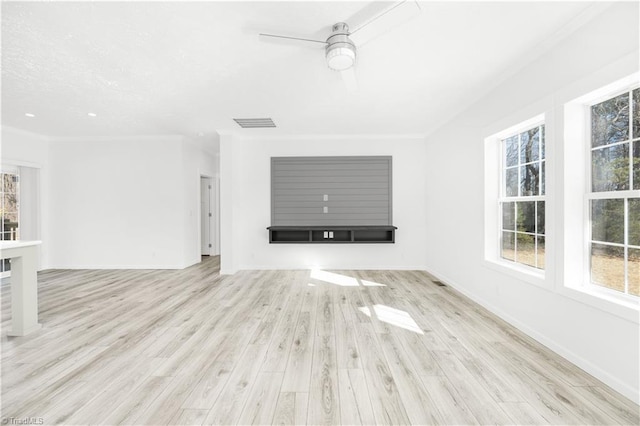 unfurnished living room with ceiling fan, crown molding, and light wood-type flooring