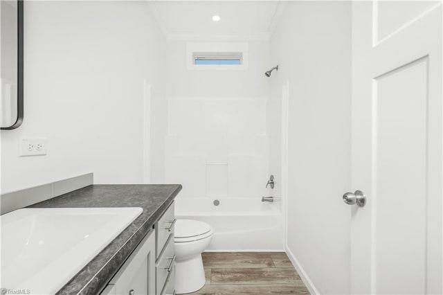 full bathroom with hardwood / wood-style floors, vanity, ornamental molding, toilet, and bathing tub / shower combination