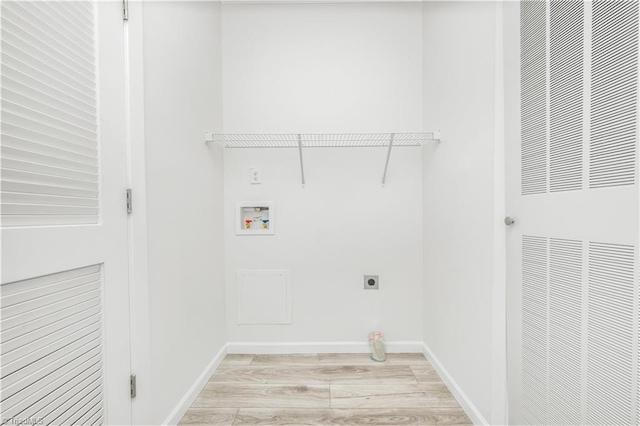 clothes washing area featuring washer hookup, hookup for an electric dryer, and light wood-type flooring