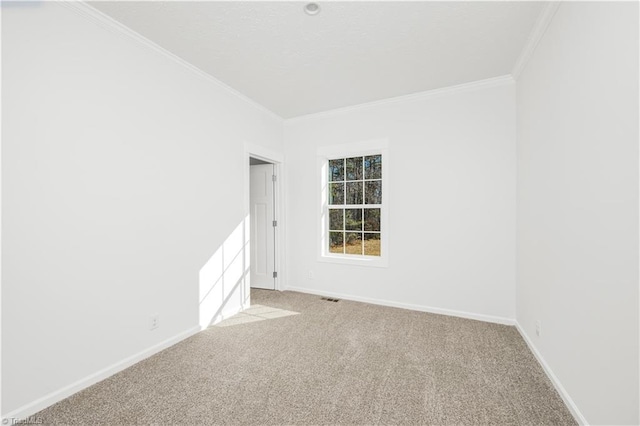 carpeted spare room with crown molding