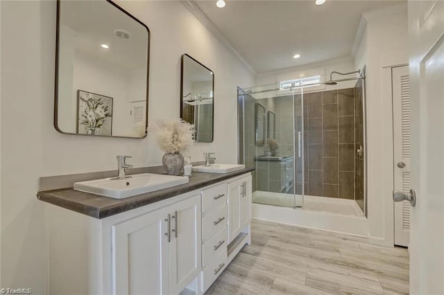 bathroom with vanity, hardwood / wood-style flooring, ornamental molding, and walk in shower