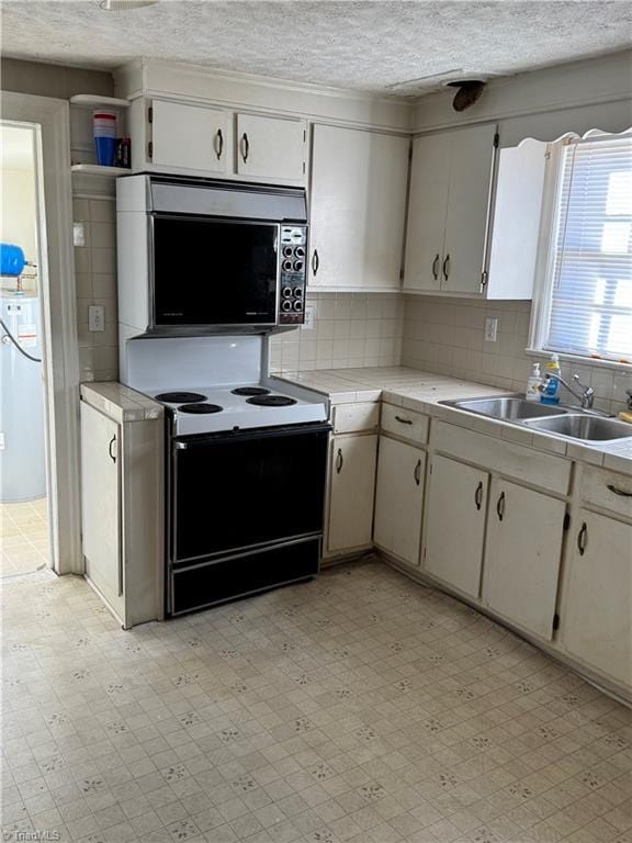 kitchen featuring decorative backsplash, a textured ceiling, sink, electric range, and white cabinets