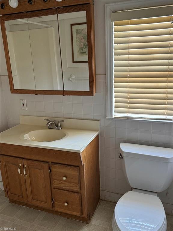 bathroom with tile patterned flooring, vanity, and toilet