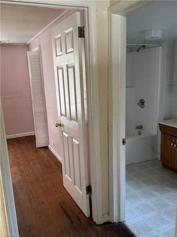 hall featuring dark wood-type flooring and ornamental molding