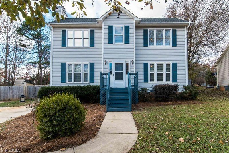 colonial home with a front lawn