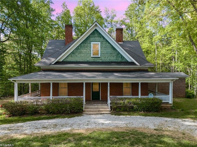 country-style home with a porch