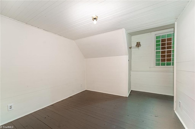 bonus room featuring vaulted ceiling and dark hardwood / wood-style flooring