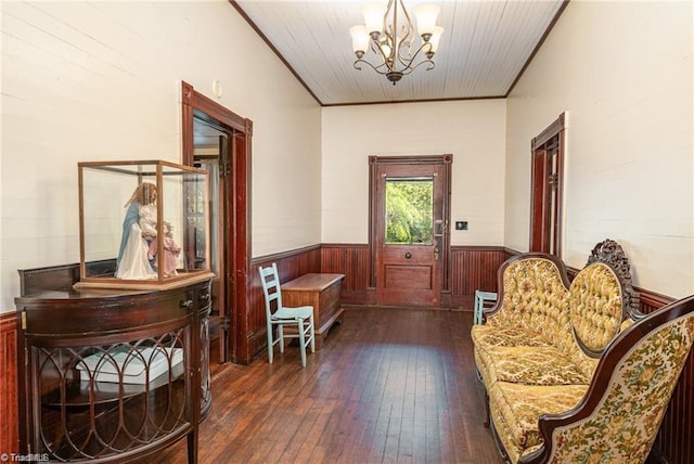 living area featuring wood ceiling, ornamental molding, dark wood-type flooring, and a notable chandelier