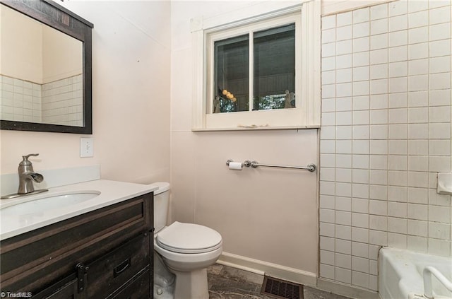 bathroom featuring a tub, vanity, and toilet