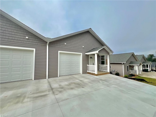 ranch-style house with a porch and a garage