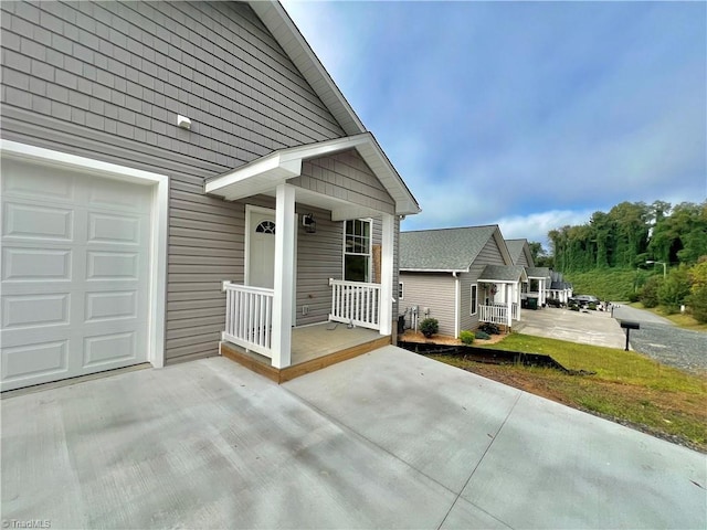 view of exterior entry featuring covered porch