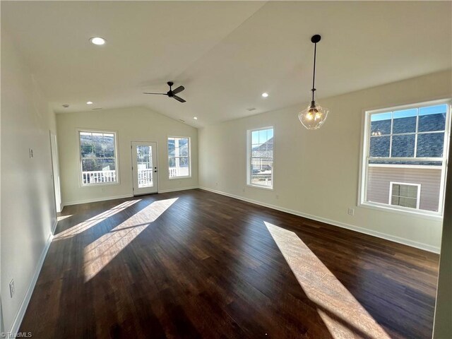 unfurnished living room with ceiling fan, dark wood-type flooring, and vaulted ceiling