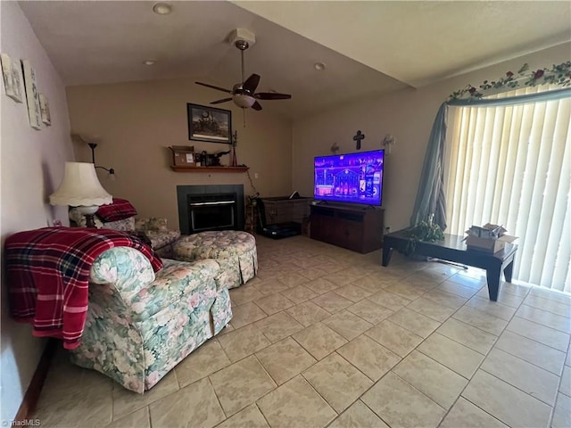 tiled living room featuring ceiling fan and vaulted ceiling