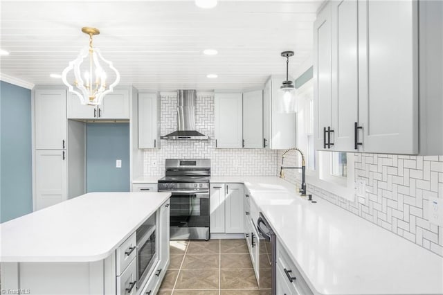 kitchen featuring light tile patterned floors, stainless steel appliances, a sink, wall chimney exhaust hood, and tasteful backsplash