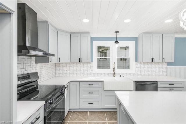 kitchen with light tile patterned floors, black electric range oven, a sink, dishwasher, and wall chimney exhaust hood