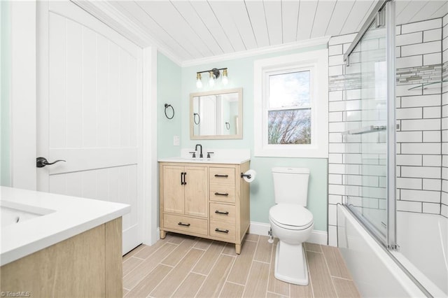 full bath with enclosed tub / shower combo, crown molding, vanity, and toilet