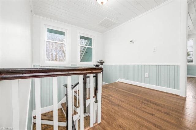 interior space with ornamental molding, wood ceiling, wainscoting, and wood finished floors