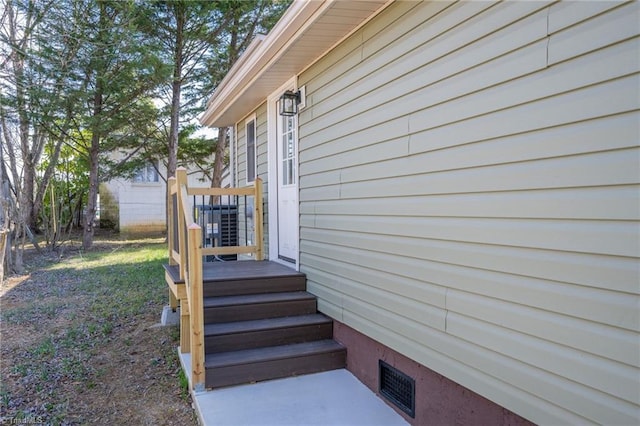 exterior space featuring cooling unit and visible vents