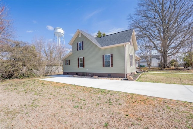 view of front of house with crawl space, a front lawn, and concrete driveway