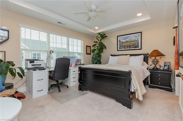 bedroom featuring light carpet, visible vents, recessed lighting, and a raised ceiling