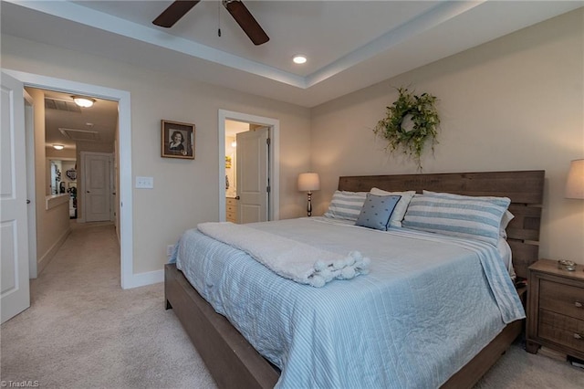 bedroom featuring baseboards, a tray ceiling, attic access, recessed lighting, and light colored carpet