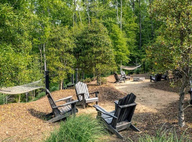 surrounding community featuring an outdoor fire pit