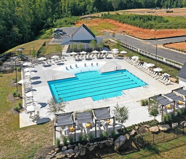 pool featuring fence and a patio area