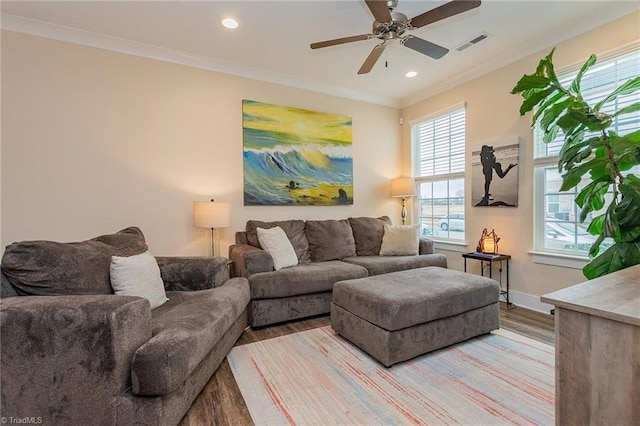 living room featuring crown molding, recessed lighting, visible vents, and light wood finished floors