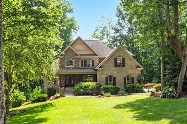 7821 Charles Place Dr, Kernersville, NC 27284 - craftsman-style home with a front yard and brick siding