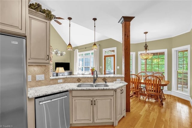 7821 Charles Place Dr, Kernersville, NC 27284 - kitchen featuring appliances with stainless steel finishes, plenty of natural light, light wood-style flooring, a peninsula, and lofted ceiling