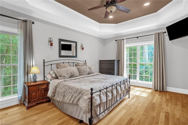 7821 Charles Place Dr, Kernersville, NC 27284 - bedroom featuring a tray ceiling, light wood-type flooring, crown molding, recessed lighting, and a ceiling fan
