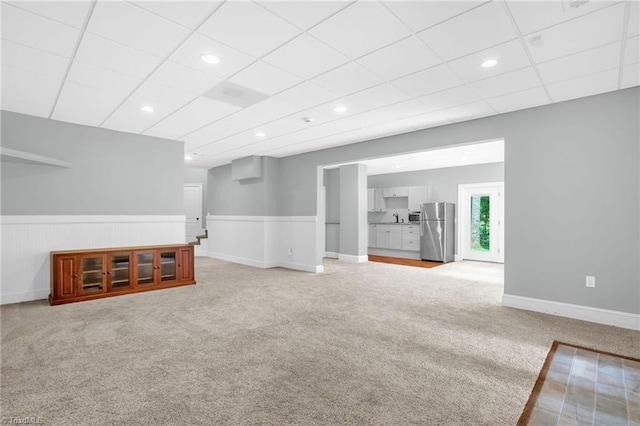 7821 Charles Place Dr, Kernersville, NC 27284 - unfurnished living room with light carpet, a wainscoted wall, a paneled ceiling, and recessed lighting