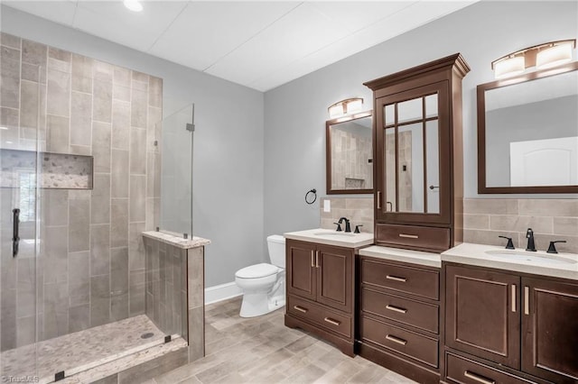 7821 Charles Place Dr, Kernersville, NC 27284 - bathroom featuring a shower stall, double vanity, wood finished floors, and backsplash