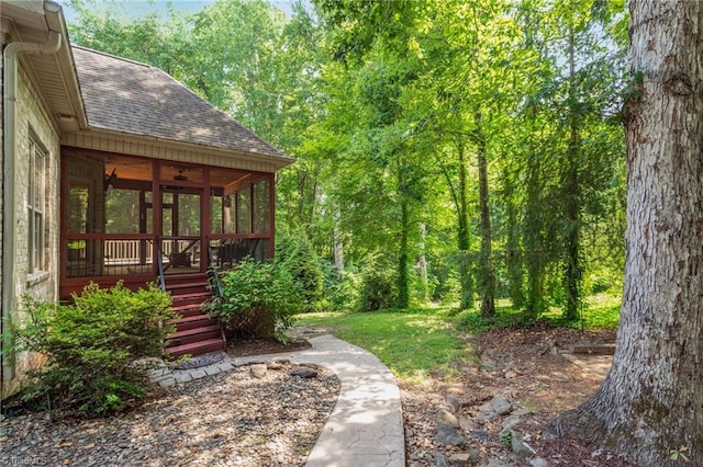 7821 Charles Place Dr, Kernersville, NC 27284 - view of yard featuring a sunroom, stairs, a forest view, and a ceiling fan