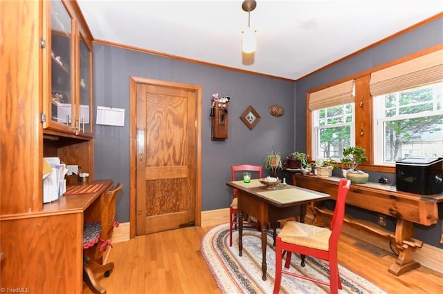 office area featuring light wood-type flooring and crown molding