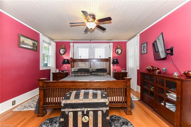 bedroom featuring ceiling fan, wood-type flooring, and ornamental molding