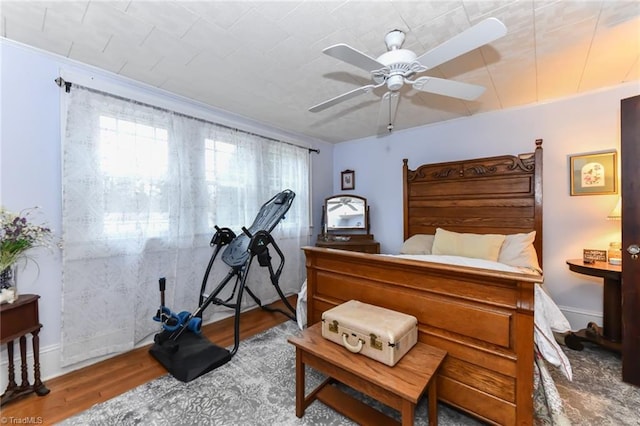 bedroom with ceiling fan and wood-type flooring